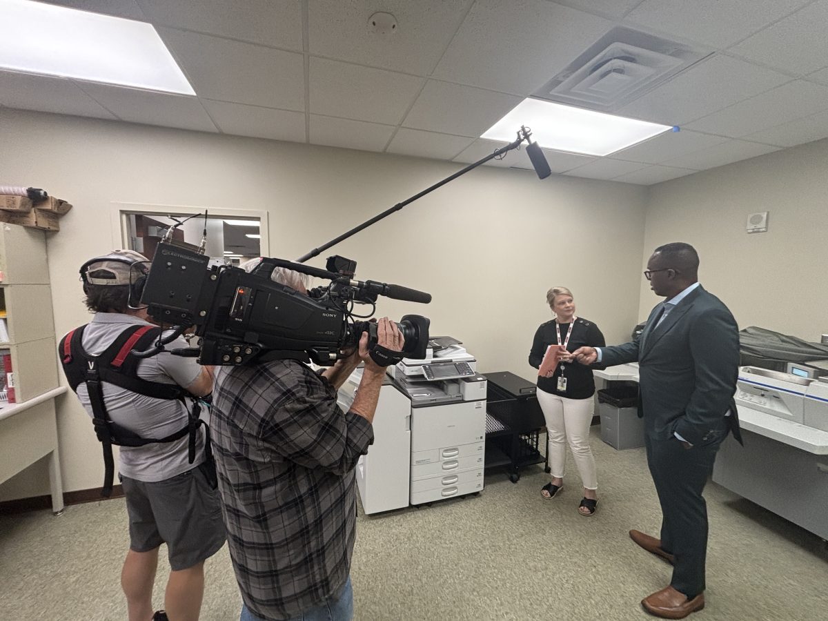 Camera operator and boom operator filming an office interview during an ABC News shoot in Paulding County, Georgia